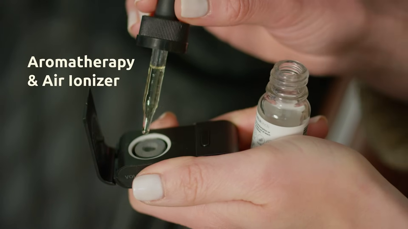 Woman putting essential oils into M8 Neo's aromatherapy diffuser.