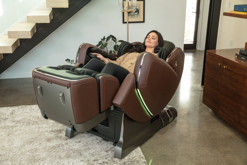 Woman laying back in M8 Neo massage chair and enjoying immersive atmosphere.