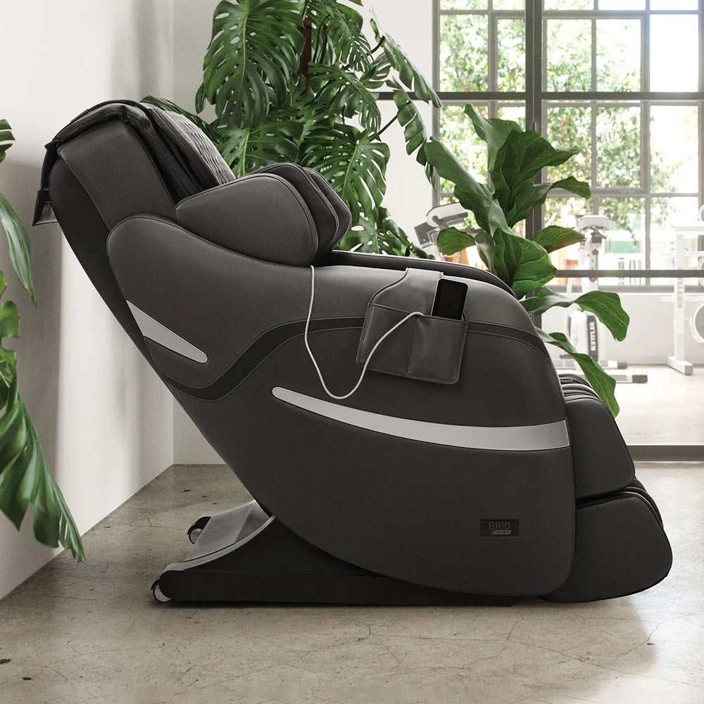 Positive Posture Brio Sport 4D massage chair with simple remote in living room by plants
