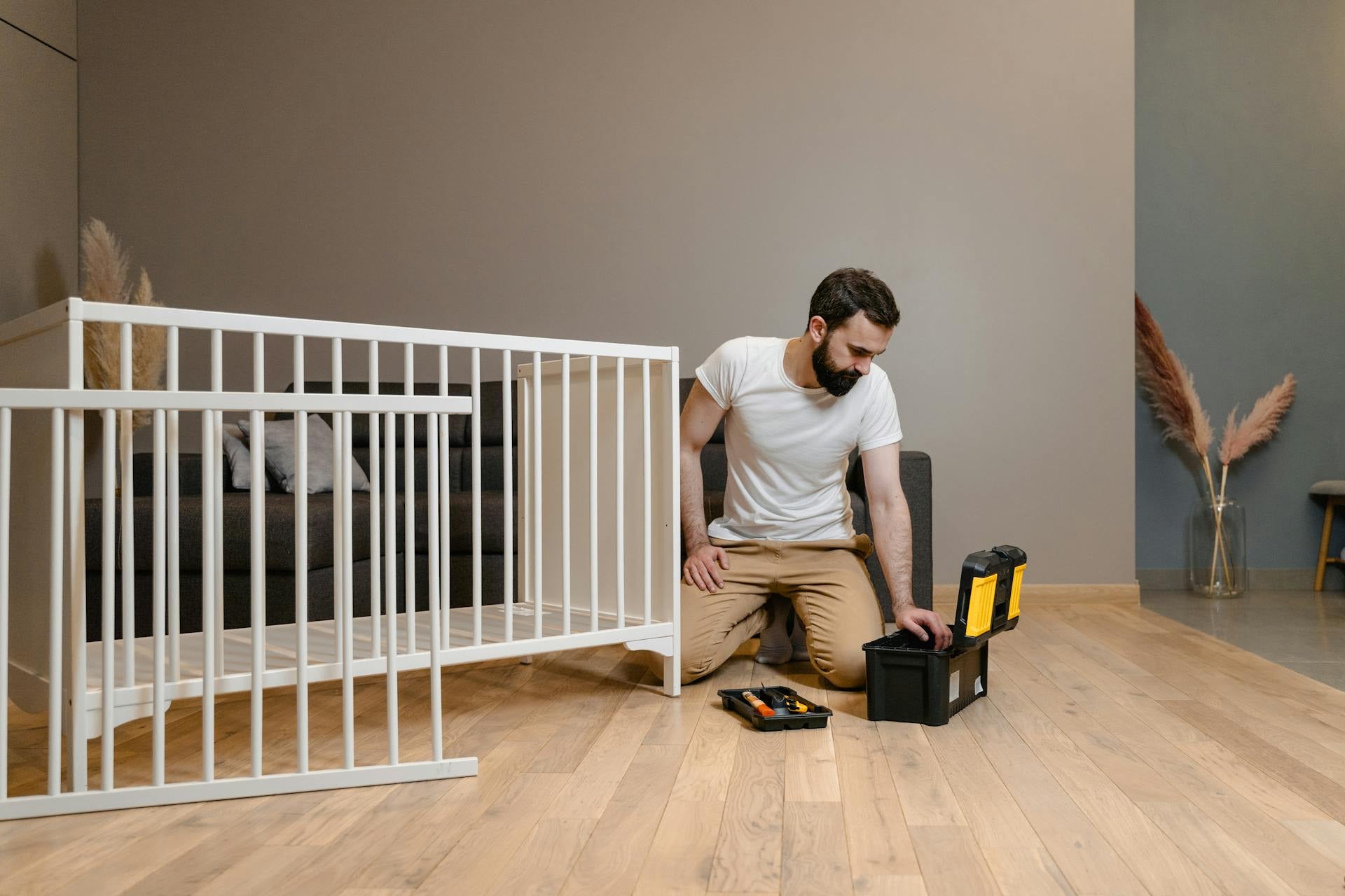 Friendly white glove delivery in-home setup technician assembling bed frame
